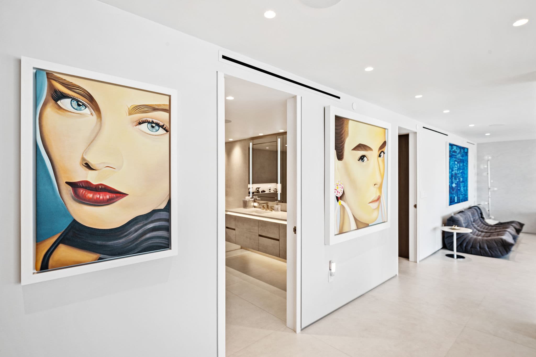Gallery hallway with oversized portrait artwork